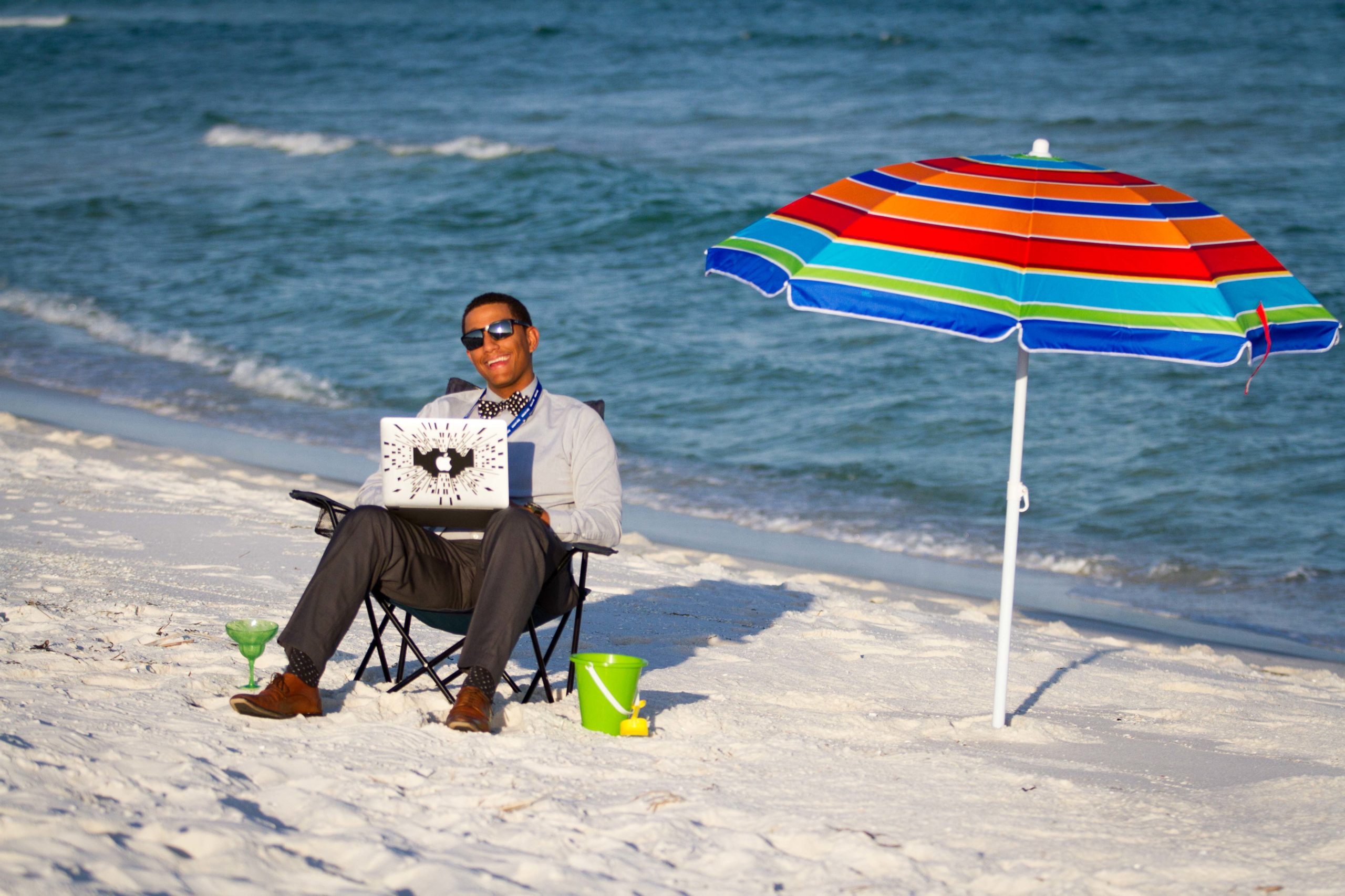 man with a laptop at the beach